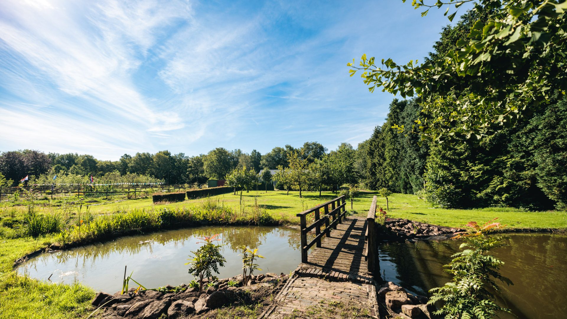 De tuin van het Werklab Westerwolde met op de voorgrond een bruggetje